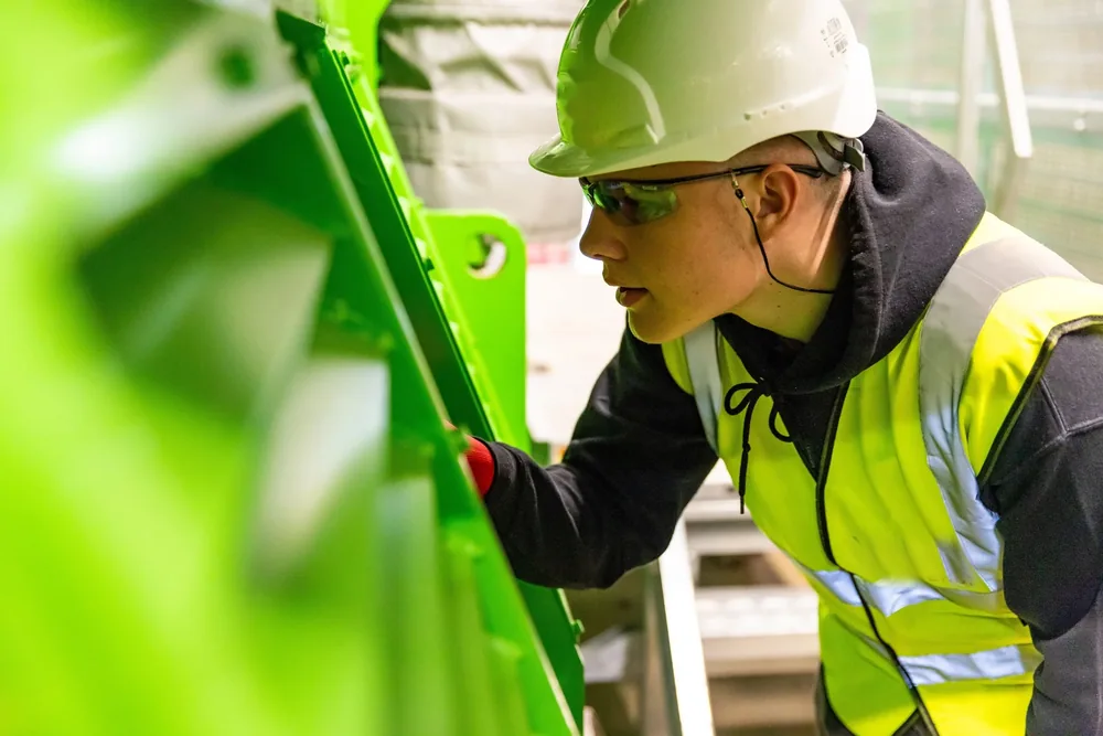 A technician inspecting equipment inside an industrial facility